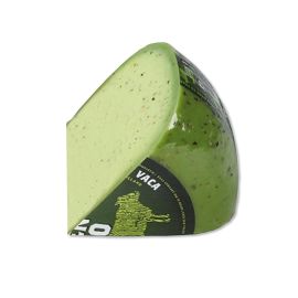 Piece of organic cow cheese with green pesto