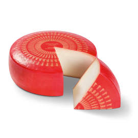 Roue de fromage Bio Glorious Goat avec un morceau découpé. Le morceau est devant la roue.