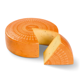 Roue de fromage Bio Tremendous Truffle avec un morceau découpé. Le morceau est devant la roue.