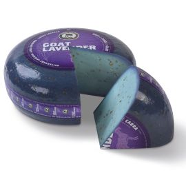 Lavender goat cheese wheel with a piece cut out