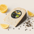 Henri Willig organic lemon pepper cheese with lemon wedges and peppercorns.