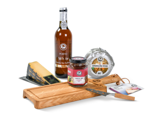 A cheese board with a small cheese knife, a bottle of port, cheese dip, and two cheeses.