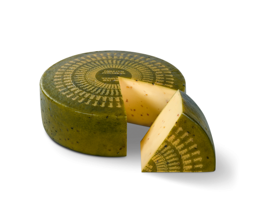 Bio Fabulous Fenugreek cheese wheel with a piece cut out. The piece is in front of the wheel.