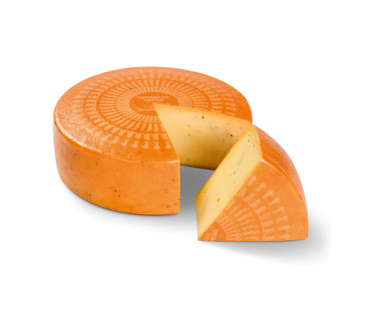 Kaaswiel Bio Tremendous Truffle met een stukje eruit gesneden. Stukje ligt voor het wiel.