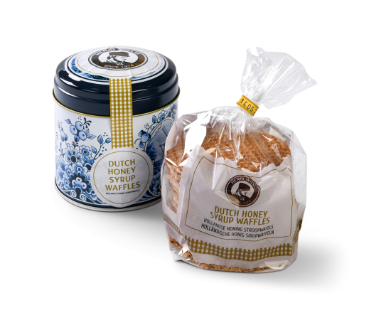Honingwafels in de verpakking met het bijpassende blik ernaast.