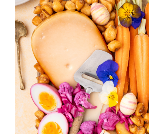 Piece of cheese on an Easter-themed cheese board.