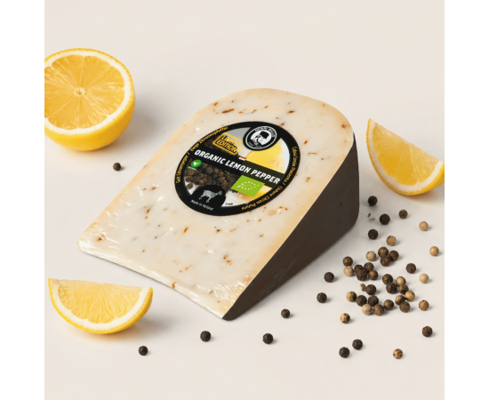 Henri Willig organic lemon pepper cheese with lemon wedges and peppercorns.