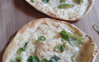 Honey thyme goat cheese pizza with fresh basil