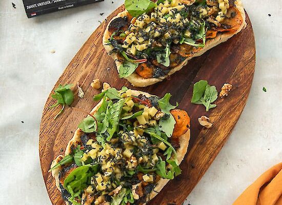 Two flatbreads on a wooden board